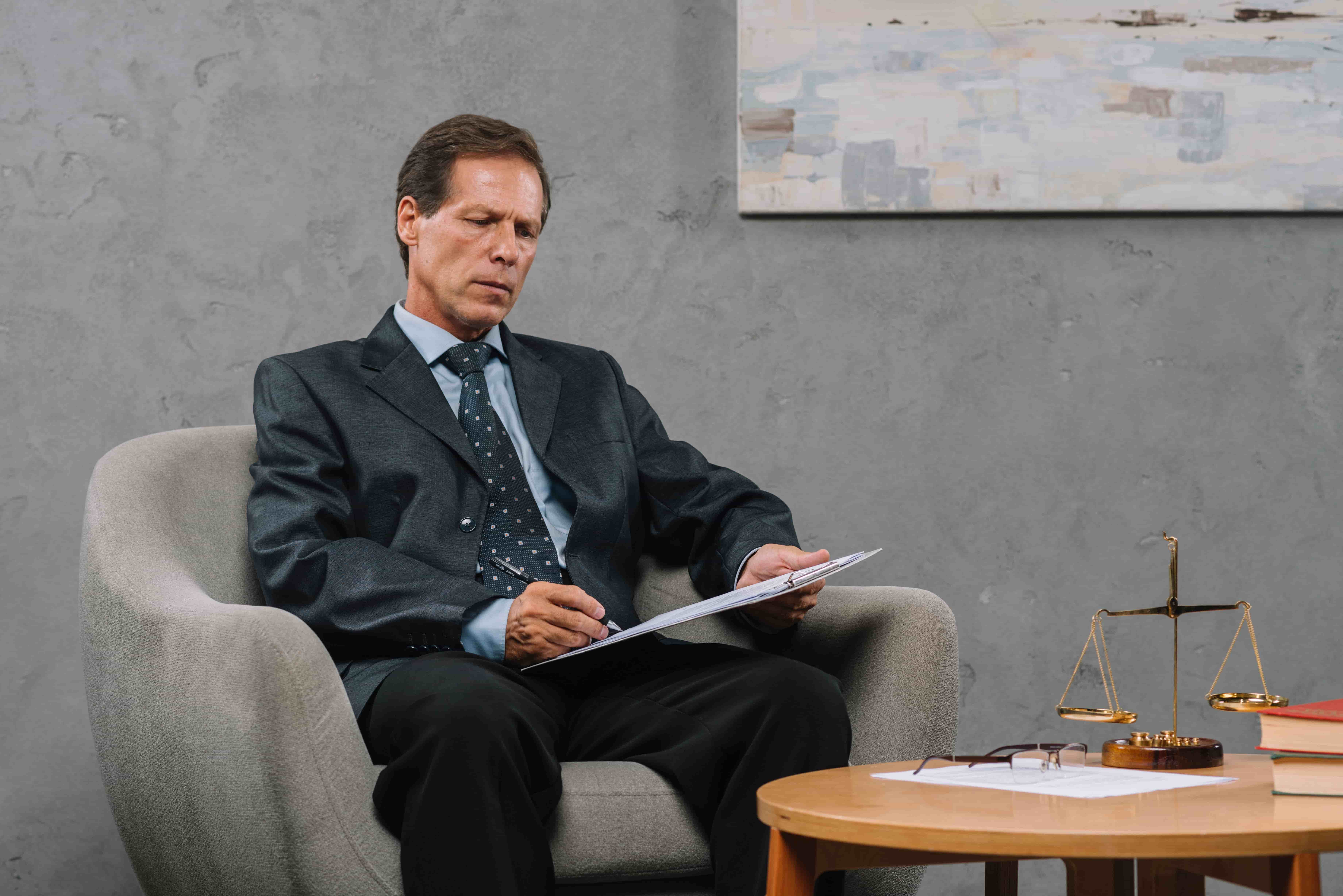 An attorney reviewing case files alone in a quiet office after a slow month of case inquiries